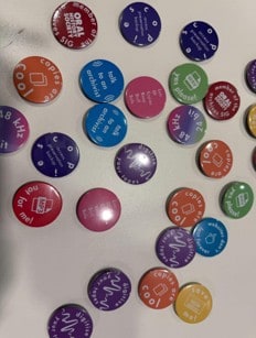 Colorful round buttons with various phrases like looks cool to me! and not to GFA standards, scattered on a white surface. Some buttons show icons or wavy lines.